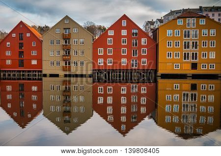 Symmetric reflection of pld houses in Trondheim Norway
