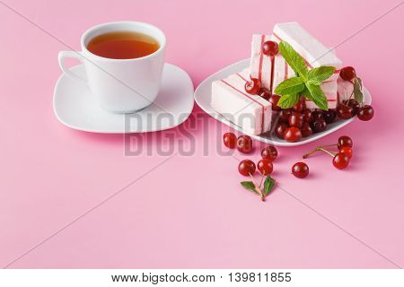 Morning snack with cherry fruit candy and tea