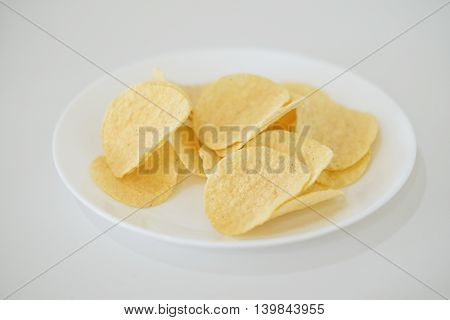 snack food of potato chips crispy  in white ceramic bowl  on white background