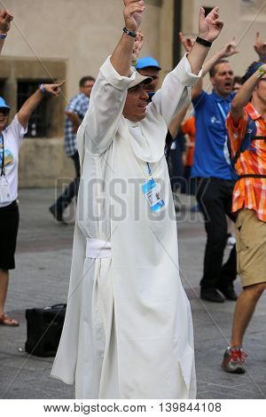 CRACOW POLAND - JULY 24 2016: Pilgrims of World Youth Day sing and dance on the Main Square in Cracow. Poland