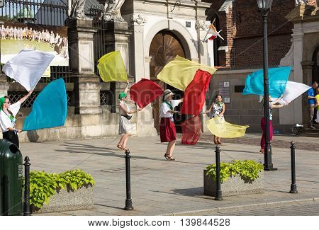 CRACOW POLAND - JULY 24 2016: Pilgrims of World Youth Day sing and dance on the St. Maria Magdalena Square in Cracow. Poland