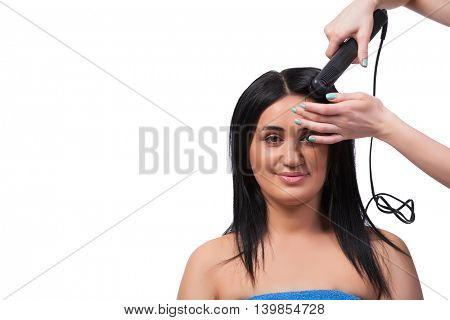 Young woman getting hair straightner isolated on white