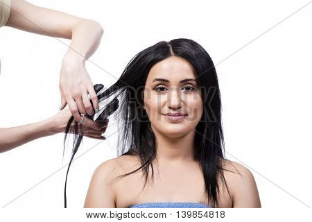 Young woman getting hair straightner isolated on white