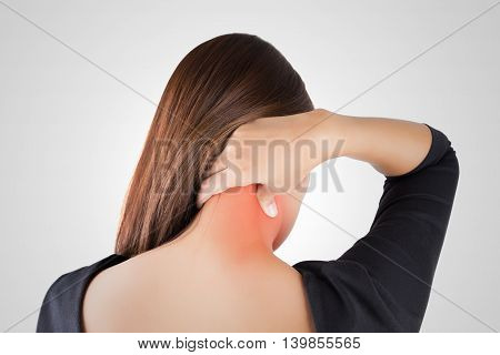 Woman having pain in the back and neck Pain in the back