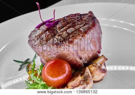 Organic delicious beef steak on white plate. Shallow dof