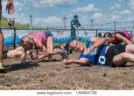 Tyumen, Russia - July 9, 2016: Steel Character extrim race on Voronino Hill. Army Test. People jumping, crawling, passing under a barbed wires or climbing obstacles during extreme obstacle race