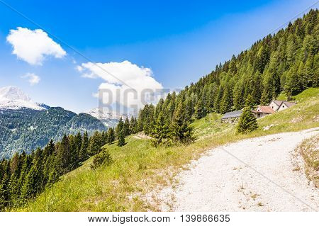 Mountain landscape with small farm (malga Alpine hut.)for mountain pasture of cows in summer. Julian Alps Italy