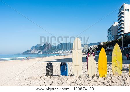 Surfboards standing upright in bright sun on the Ipanema beach Rio de Janeiro Brazil