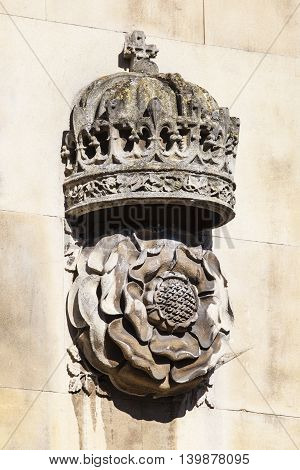 A carving of a Royal Crown and Tudor Rose on the exterior of the gatehouse at King's College in Cambridge UK.