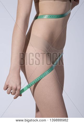 Body of woman with a measuring tape