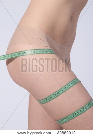 Body of woman with a measuring tape
