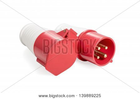 Red and white three-phase plug and socket with a lid lying beside isolated on white background