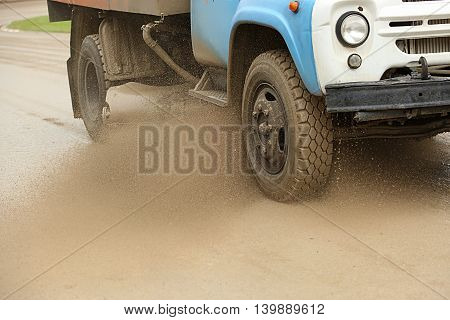 Sweeper Cleans Dirt Road