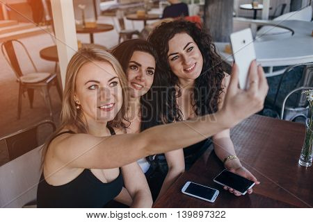 Girls walking around town, sit in cafes and pictures on phones