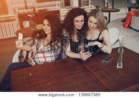 Girls walking around town, sit in cafes and pictures on phones