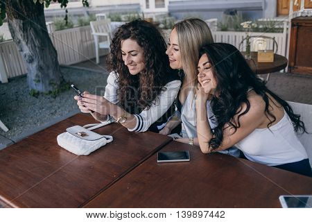 Girls walking around town, sit in cafes and pictures on phones