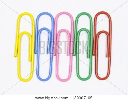 colored paper clips on a white background