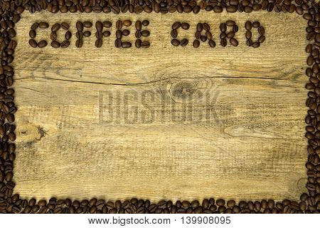 coffee card from natural coffee beans on a wooden background