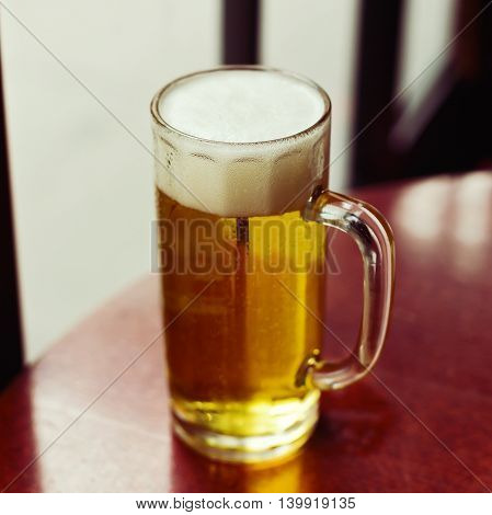 Glass of beer on table. Shallow depth of field