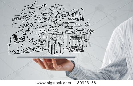 Businessman hand demostrating business strategy plan on tablet screen