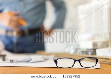 Business architect desk on wooden table architectural concept