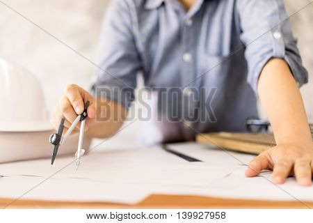 business architect drawing on blueprint architectural concept soft focus