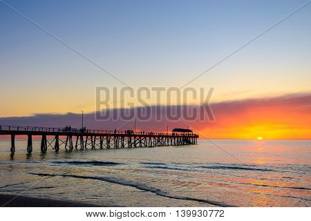 People relaxing on the Henley Beach Jetty at sunset South Australia