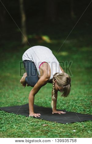 crow position yoga position,  toned image, vertical image