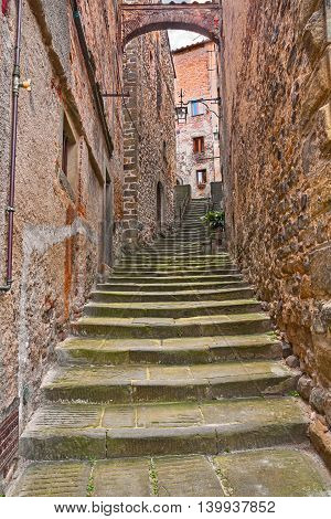 Anghiari, Arezzo, Tuscany, Italy: picturesque ancient narrow alley with staircase and arch in the Tuscan medieval village
