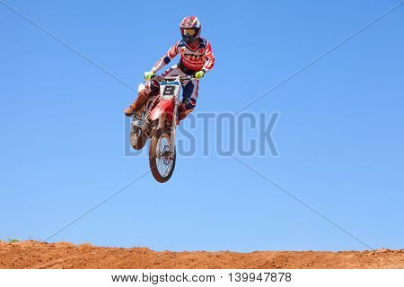 Wingate, Israel - July 23, 2016: Motocross rider and bike clearing a tabletop jump during the final heat of the race.