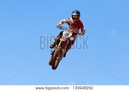 Wingate, Israel - July 23, 2016: Motocross rider and bike clearing a tabletop jump during the final heat of the race.