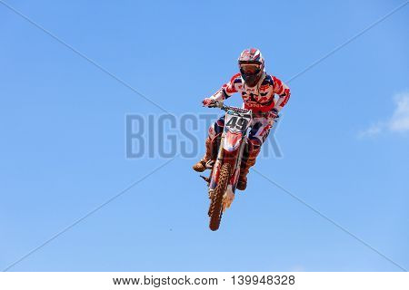 Wingate, Israel - July 23, 2016: Motocross rider and bike clearing a tabletop jump during the final heat of the race.