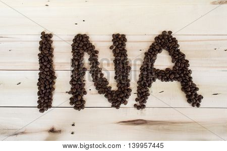 Ina Text Acronym India, Coffee Beans Arranged Shaped On Wood Background.