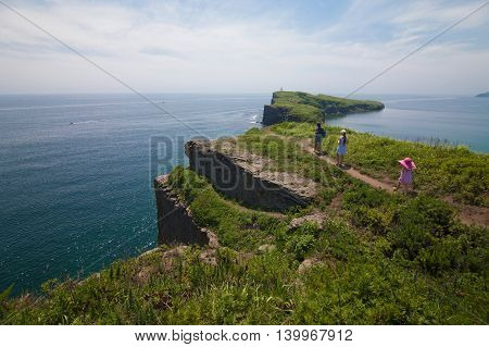 Mother with her daughters walking near sea