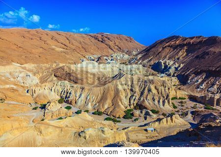 Ancient mountains in the valley of the Dead Sea. Picturesque multicolored sandstone dry talus