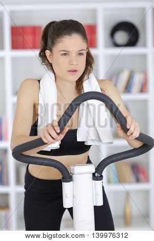 sporty woman training on exercise bike