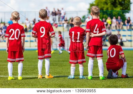 Football soccer match for children. Youth football soccer team on sport stadium. Sports school tournament for children.