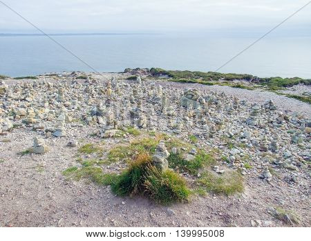 coastal scenery with lots of small stacked stone piles at the Crozon peninsula in Brittany France