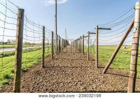 Lublin, Poland - April 14, 2018: Along The Barbed-wire Double-fence On The Nazi German Majdanek Camp