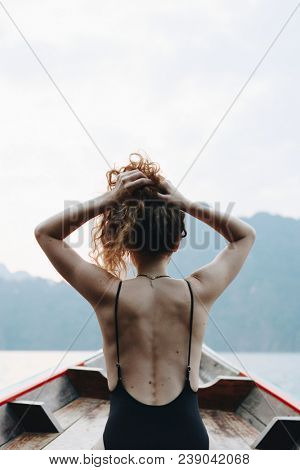 Beautiful woman posing on a boat