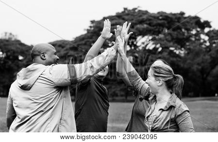 Diverse people making a high five