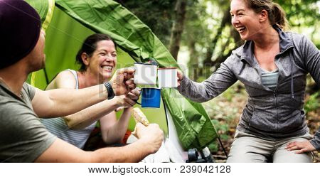 Group of diverse friends camping in the forest