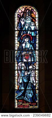 PARIS, FRANCE - JANUARY 08, 2018: Scenes from the life of the Saint Margaret Mary Alacoque, stained glass window in Basilica of the Sacre Coeur, dedicated to the Sacred Heart of Jesus in Paris, France