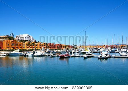 Portimao, Portugal - June 7, 2017 - Luxury Yachts And Motorboats Moored In The Marina With Apartment