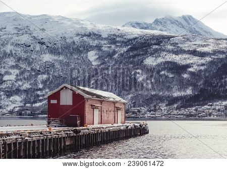 Norway, A Warehouse On The Pier At Narvik Port On A Winter Day With Snow, With Ankenes On The Other 