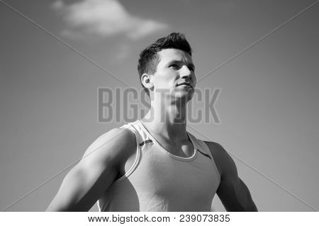 Athlete In Green Tshirt On Sunny Day. Fitness Model With Muscular Hands, Biceps, Triceps, Strong Mus