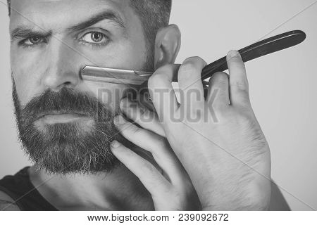 Fashion And Beauty, Innovation. Haircut Of Bearded Man, Archaism. Man Cut Beard And Mustache With Ra