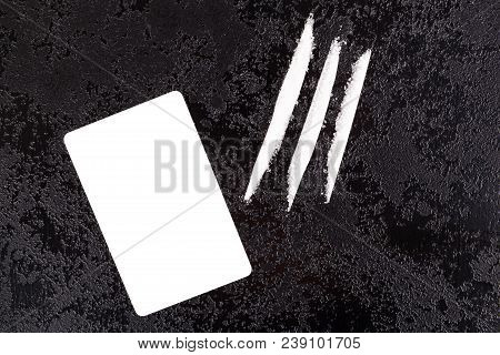 Cocaine Lines With Blank White Card On Dark Surface From Above.