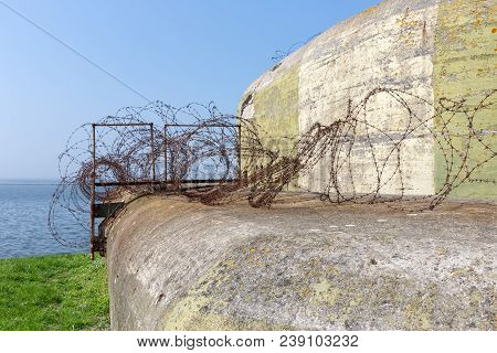 Ww2 Concrete Shelter With Barbed Wire Near Kornwerderzand At Dutch Afsluitdijk