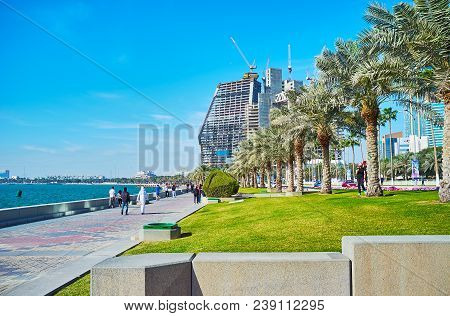 Doha, Qatar - February 13, 2018: The Daily Seaside Walk On Al Corniche Promenade, Stretching Along T